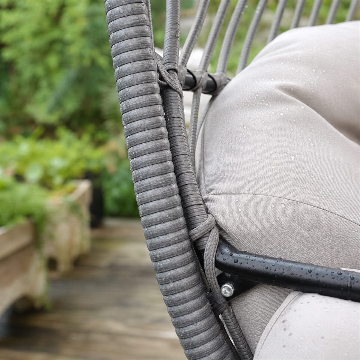 Outdoor hanging egg chair wicker frame and cushion material detail